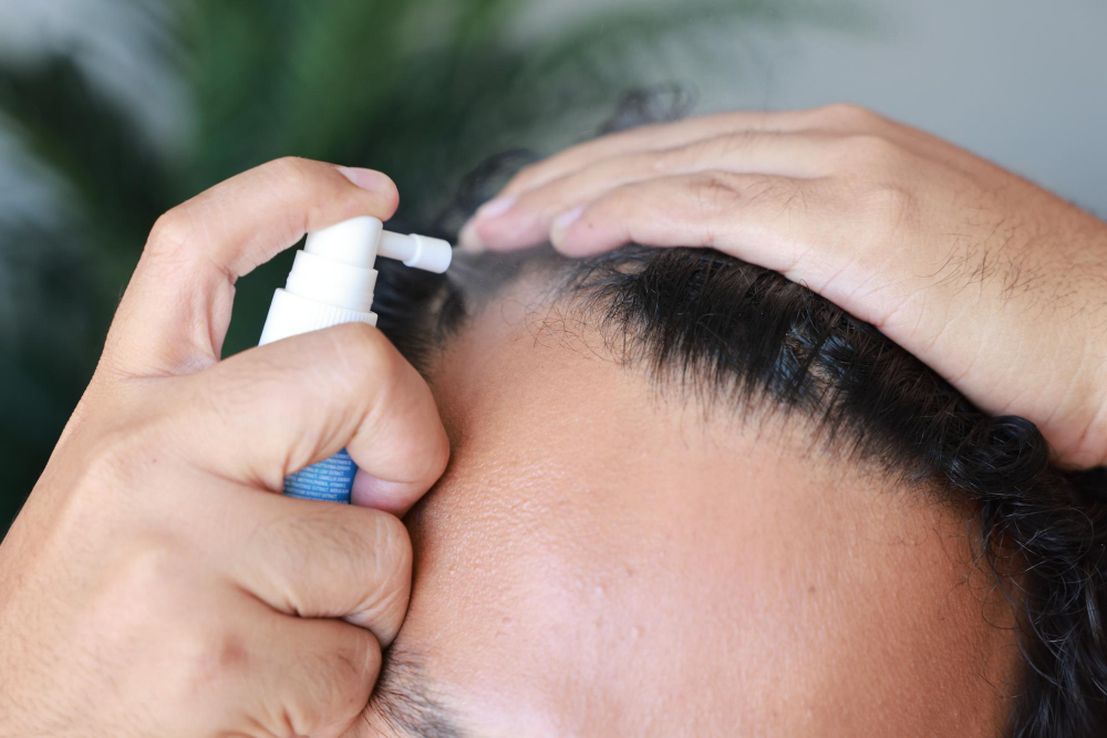 Man applying serum on his scalp